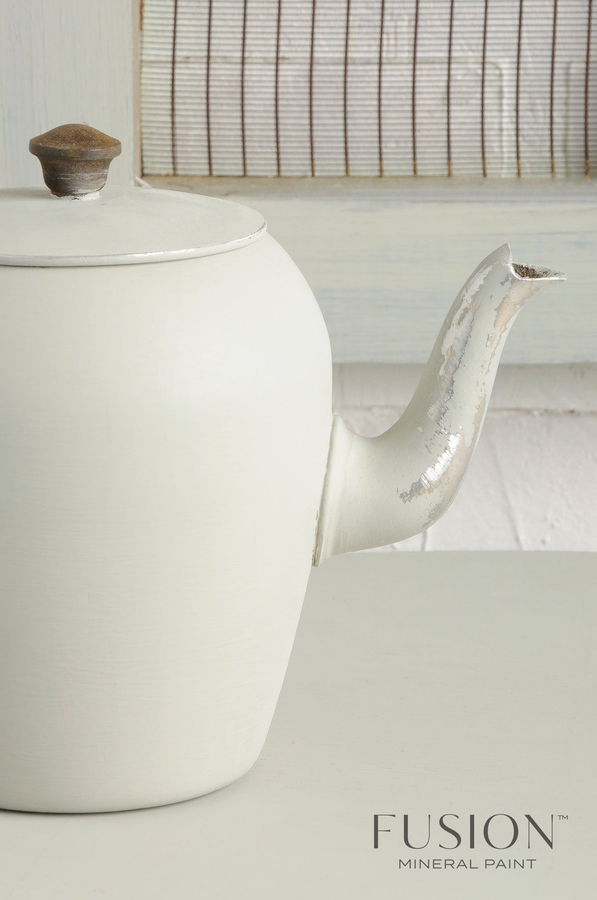 White vintage teapot with chipped spout; Fusion Mineral Paint “Bedford” shown in lower right corner.