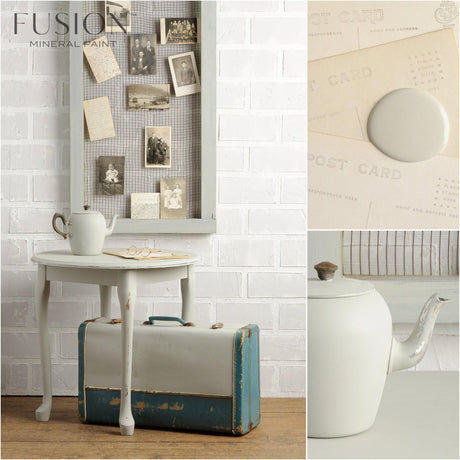 Small table, teapot, and blue suitcase in front of wall painted Bedford Fusion Mineral Paint matte finish.