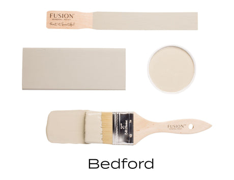 Fusion Mineral Paint Bedford in four views: painted swatch, container, stick, and brush, showing its neutral grey shade.