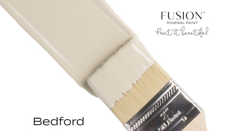 Paintbrush featuring Fusion Mineral Paint’s Bedford matte finish on bristles, shown on a plain background.