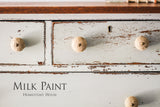 White dresser with round knobs, chipped paint, finished in Bedford Milk Paint by Homestead House.