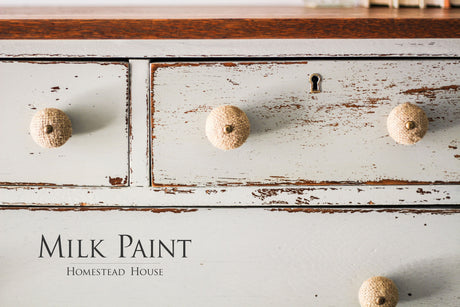 White dresser with round knobs, chipped paint, finished in Bedford Milk Paint by Homestead House.