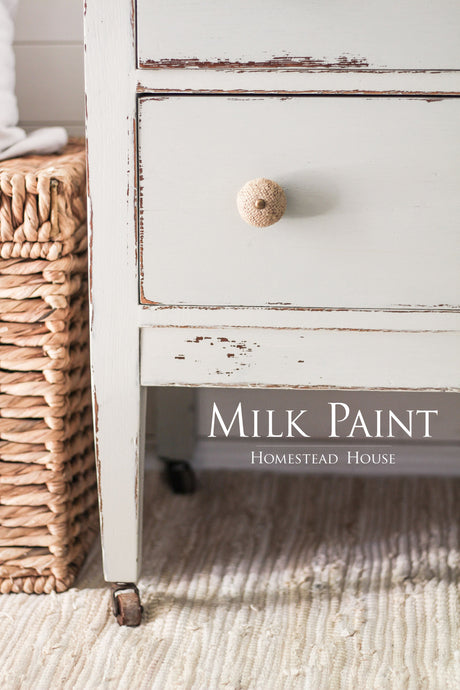 Distressed white drawer with woven knob, next to a wicker basket; Homestead House Bedford Milk Paint shown.