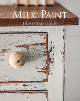 Wooden drawer with chipped Bedford Milk Paint by Homestead House and a round knob.
