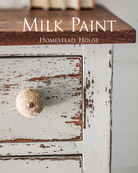 Wooden drawer with chipped Bedford Milk Paint by Homestead House and a round knob.