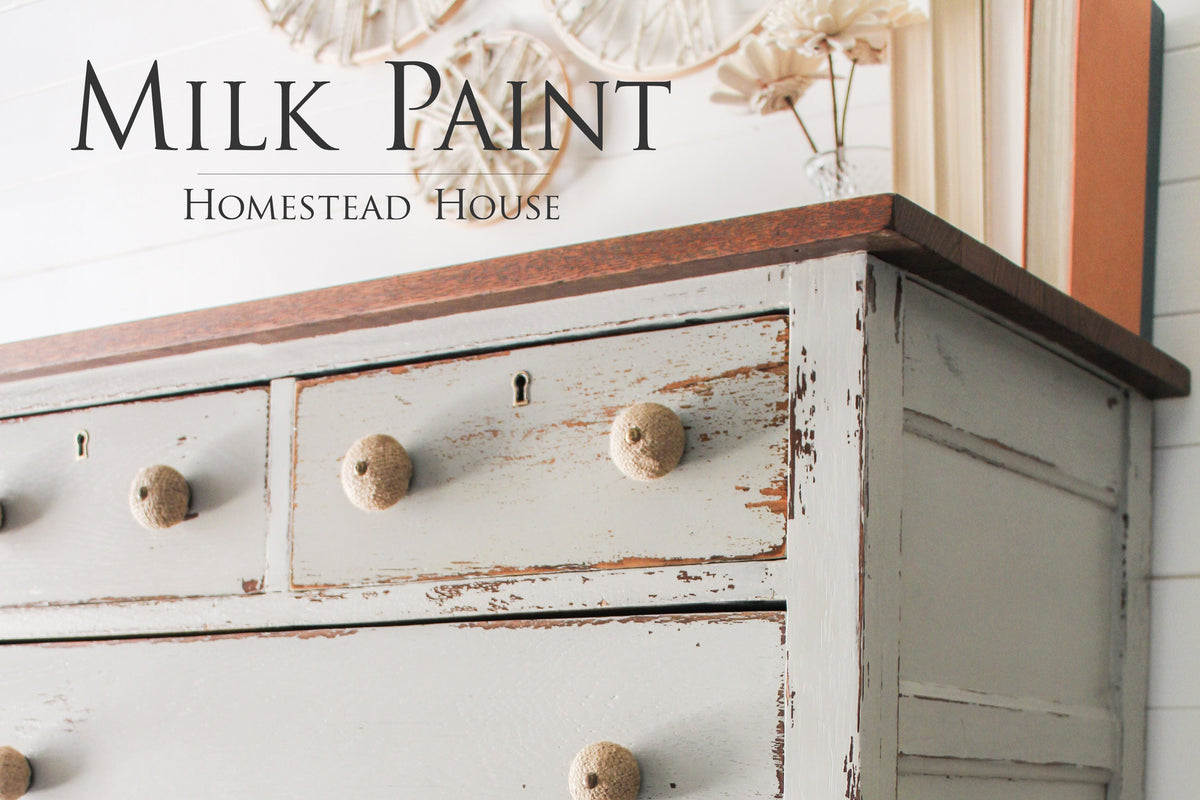 Distressed light grey dresser with round knobs, dark wood top, finished in Bedford Milk Paint by Homestead House.