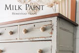Distressed light grey dresser with round knobs, dark wood top, finished in Bedford Milk Paint by Homestead House.