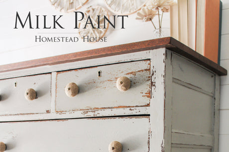 Distressed light grey dresser with round knobs, dark wood top, finished in Bedford Milk Paint by Homestead House.