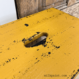 Old Fashioned Milk Paint yellow Beeswax Bar, distressed finish, handle slot, brand mark at bottom.