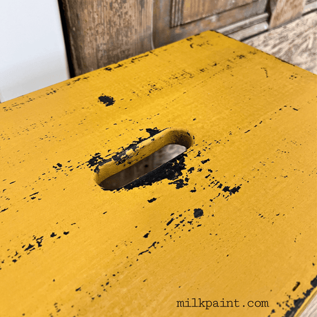 Old Fashioned Milk Paint yellow Beeswax Bar, distressed finish, handle slot, brand mark at bottom.