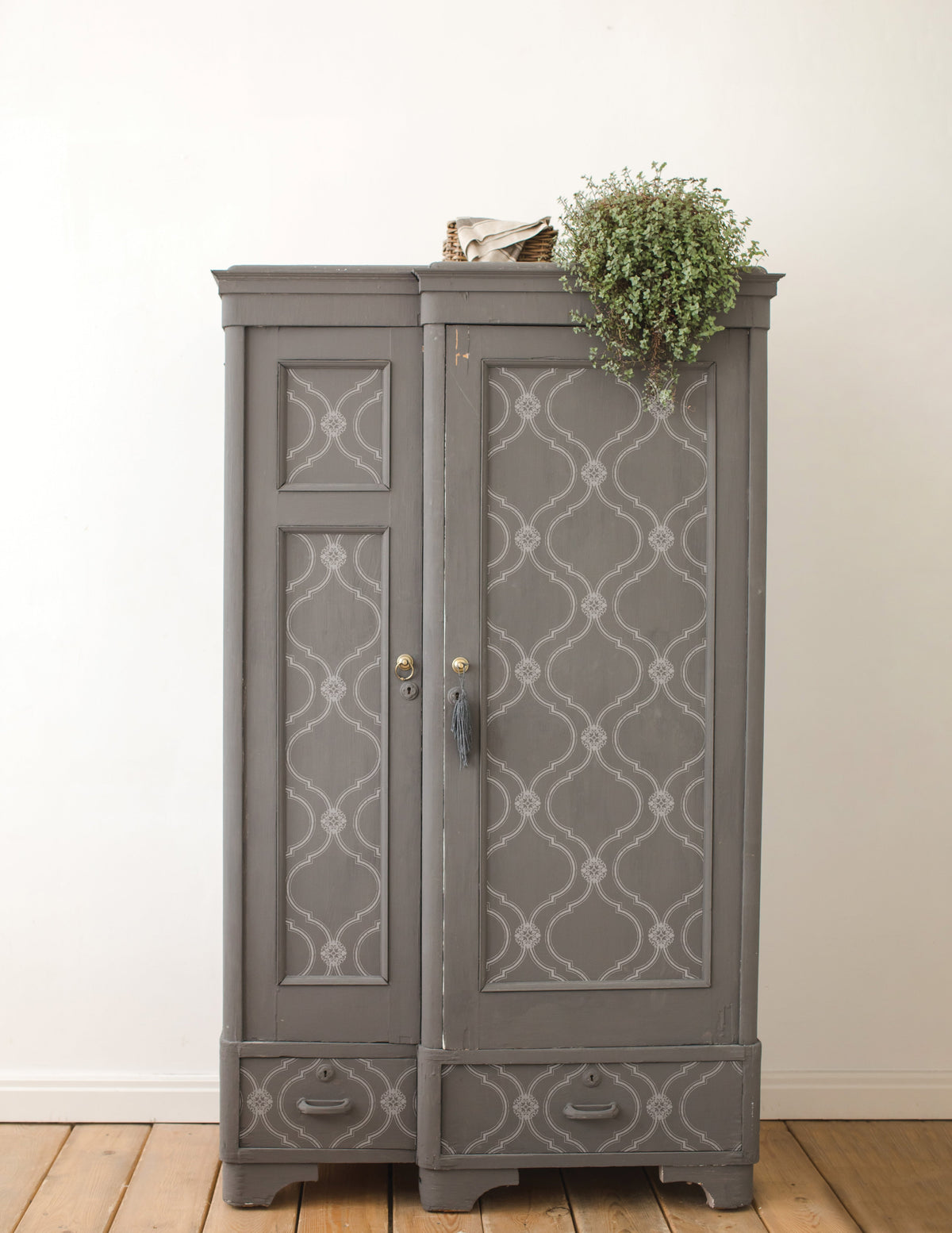 Gray vintage wardrobe with patterned doors; a plant and I.O.D. Bella Stamp (Retired) displayed on top.