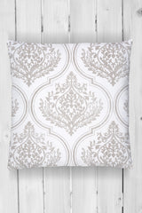 Square pillow with light gray ornate Bella Stamp (Retired) by I.O.D. pattern on white wood planks.