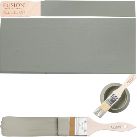 Bellwood Fusion Mineral Paint in sage green on wood, with can, brush, and painted paintbrush nearby.