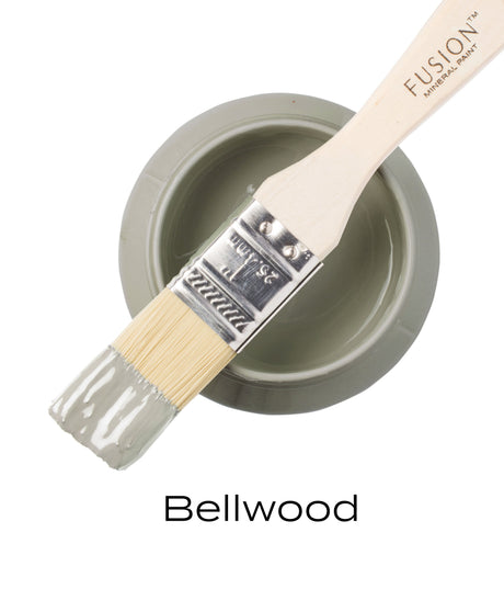 Paintbrush on open jar of Bellwood Fusion Mineral Paint in soft sage green.