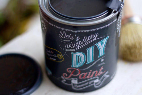 Open Black Velvet DIY Paint by DIY Paint Co. with lid and brush on a white surface.
