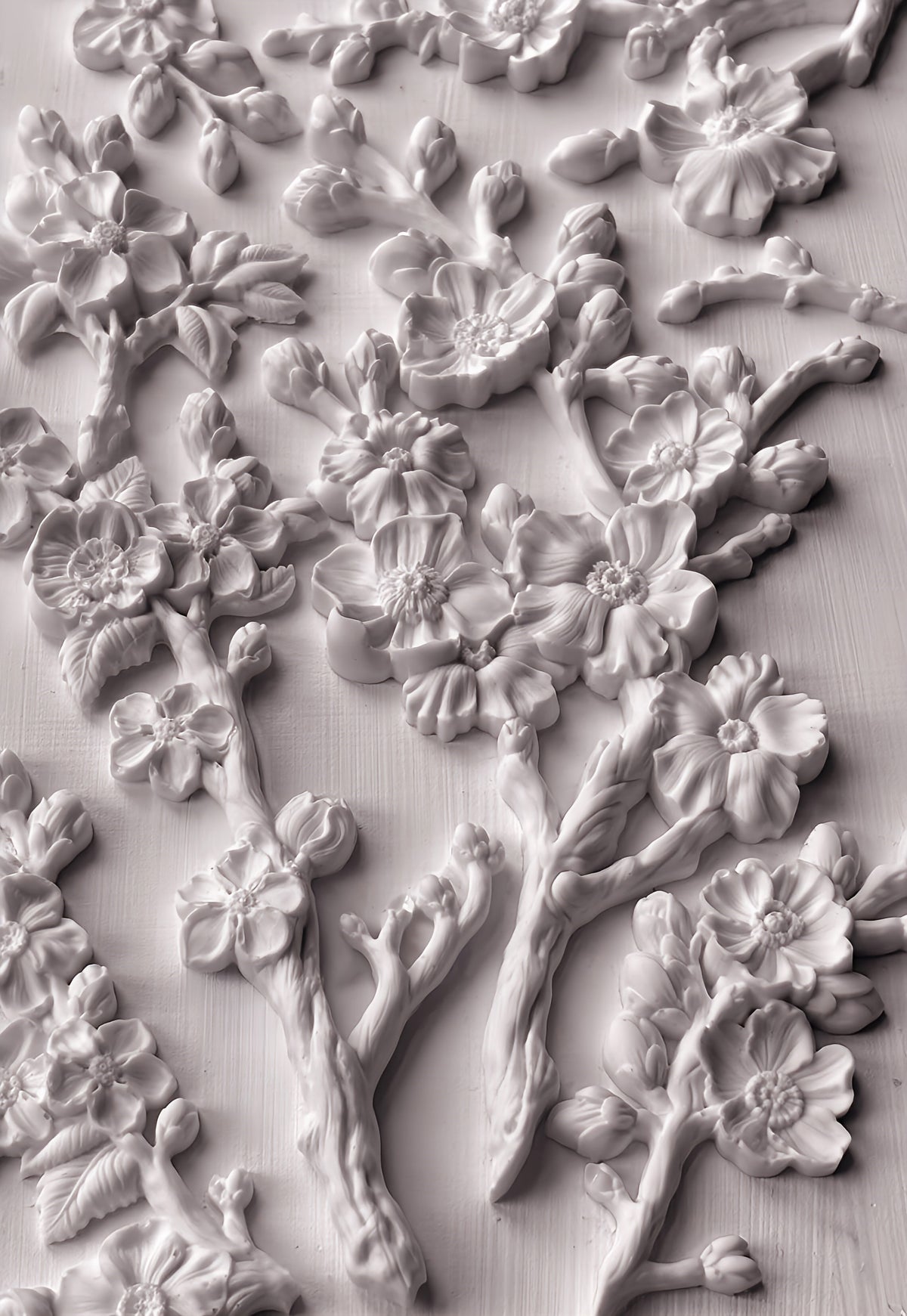 White plaster cherry blossoms made with IOD Blossom Mould displayed on a flat surface.