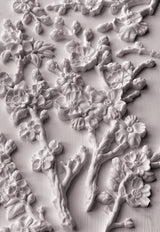 White plaster cherry blossoms made with IOD Blossom Mould displayed on a flat surface.