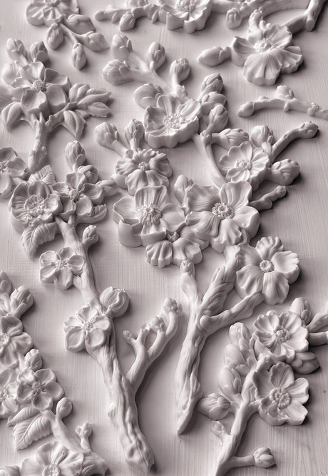 White plaster cherry blossoms made with IOD Blossom Mould displayed on a flat surface.