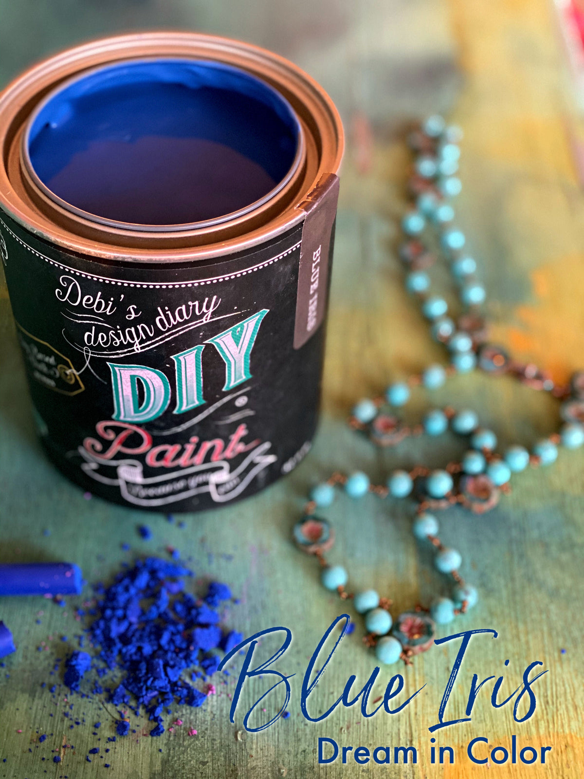 Open can of Blue Iris DIY Paint by DIY Paint Co. with blue beads, powder, and “Dream in Color” text.