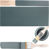 Two brushes, an open can, and a Blue Pine Fusion Mineral Paint sample showing a matte teal-blue finish.