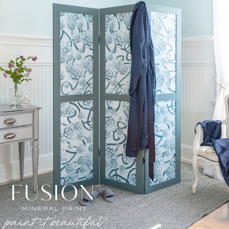 Blue floral folding screen in Fusion Mineral Paint Blue Pine, positioned beside a desk with a robe and slippers nearby.