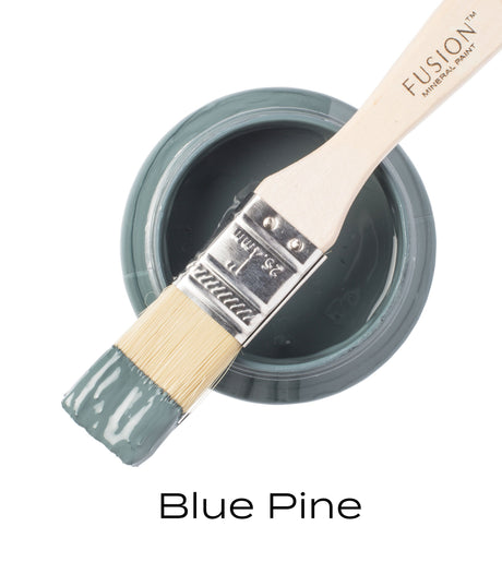 Open jar of Fusion Mineral Paint Blue Pine, matte blue-green, paintbrush resting on top, text: Blue Pine.
