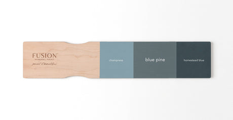 Fusion Mineral Paint swatches: Champlain, Blue Pine, and Homestead Blue displayed on a wooden board.