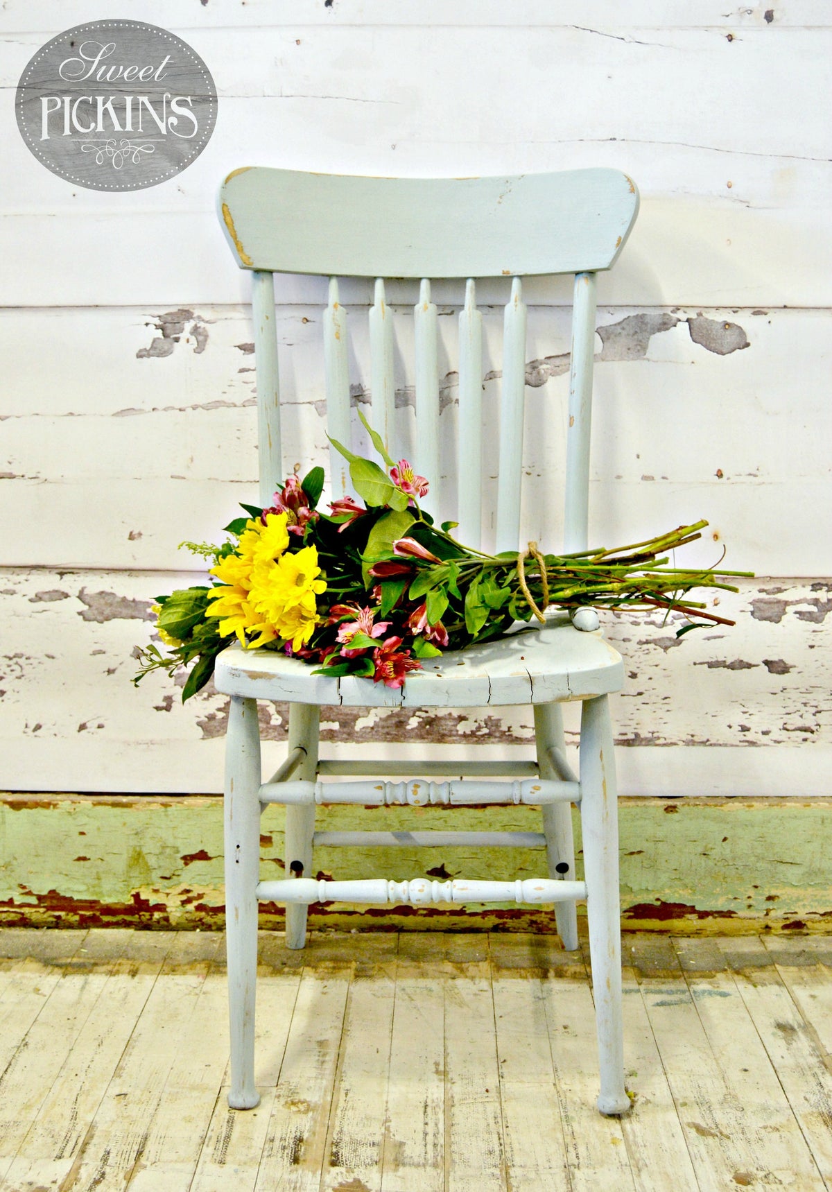 Bluebird by Old Fashioned Milk Paint chair holding mixed flowers.