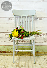 Bluebird by Old Fashioned Milk Paint chair holding mixed flowers.