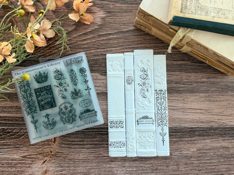 The Connoisseur’s Library Mini Stamp by IOD with white book shapes from I.O.D. displayed together.