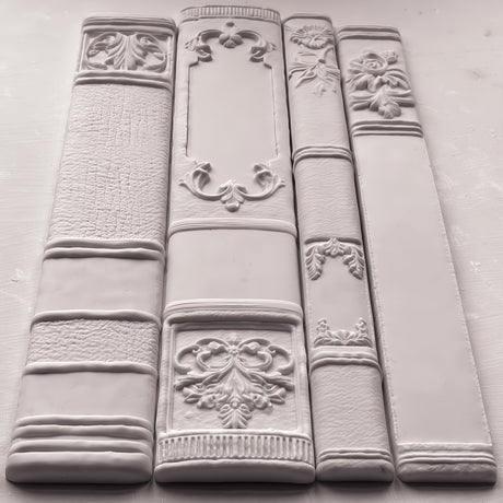 Bookish Mould by I.O.D. featuring vintage-style book spine tiles arranged side by side for faux library decor.