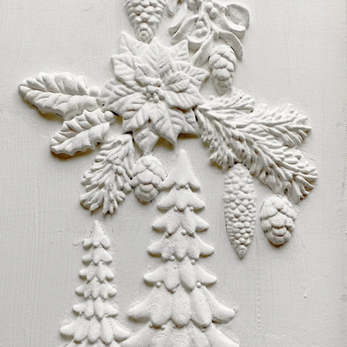 White textured design featuring pine trees, poinsettias, and pinecones using I.O.D. Boughs of Holly (2026 Limited Release).