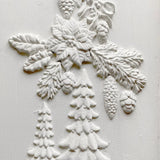 White textured design featuring pine trees, poinsettias, and pinecones using I.O.D. Boughs of Holly (2026 Limited Release).