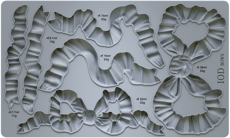 I.O.D. Bows Mould: gray silicone tray with bow shapes, each marked by volume and weight, by Iron Orchid Designs.