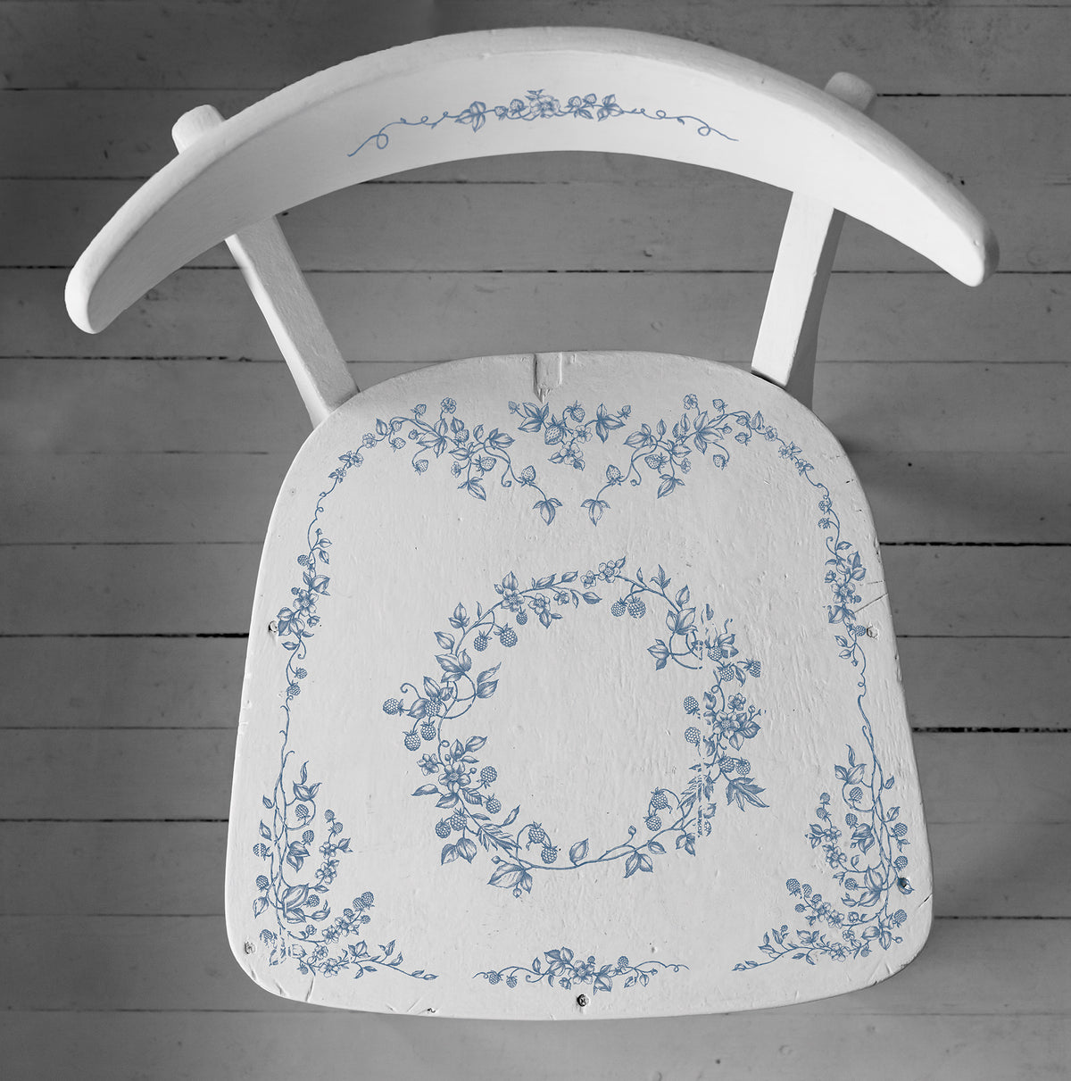 White wooden chair with blue floral designs, made using I.O.D. Brambles & Berries Stamp by Iron Orchid Designs.