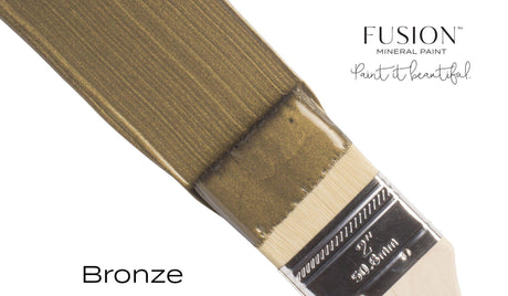Paintbrush with Fusion Mineral Paint in Bronze Metallic, labeled “Bronze.”.