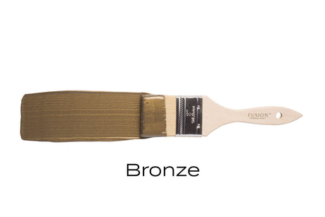 Brush with Bronze Metallic Fusion Mineral Paint on bristles, labeled “Bronze” against a white background.