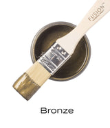 Brush resting on open can of Bronze Metallic Fusion Mineral Paint; “Bronze” text displayed below.