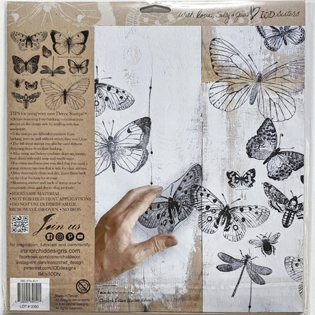 Hand displaying prints made with IOD Butterflies Stamp using reusable stamping masks from Iron Orchid Designs.