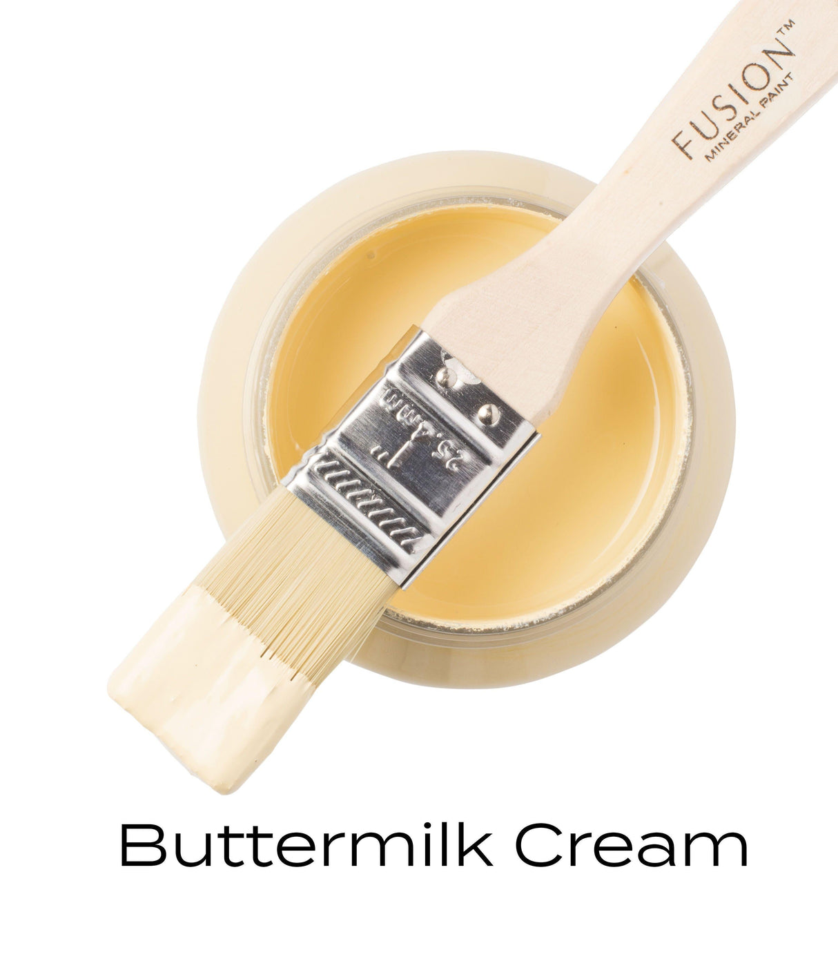 Open Fusion Mineral Paint Buttermilk Cream (Seasonal) jar with brush resting on top, bristles coated in yellow paint.