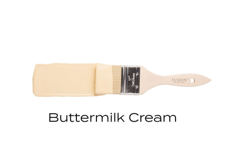 Brush with Fusion Mineral Paint Buttermilk Cream (Seasonal) on white, showing creamy yellow paint finish.