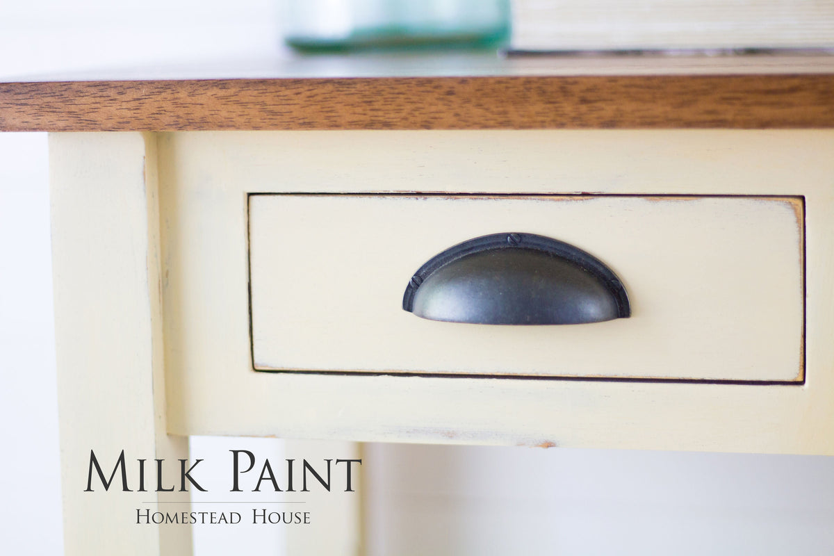 Cream desk finished in Buttermilk Cream Milk Paint by Homestead House, featuring a black drawer pull.