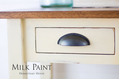 Cream desk finished in Buttermilk Cream Milk Paint by Homestead House, featuring a black drawer pull.