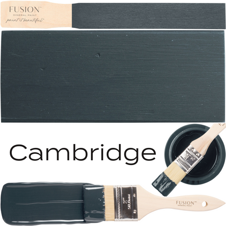 Cambridge Fusion Mineral Paint dark blue-gray rectangular swatch with paintbrushes and a small bowl nearby.