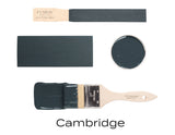 Fusion Mineral Paint “Cambridge” sample, dark grayish-green, on brush, wood, and paint can lid.