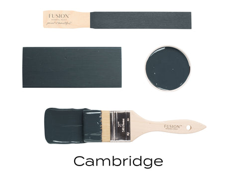 Fusion Mineral Paint “Cambridge” sample, dark grayish-green, on brush, wood, and paint can lid.