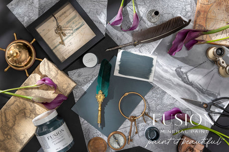Maps, calla lilies, keys, and paint jars arranged beside the Cambridge Fusion Mineral Paint logo.