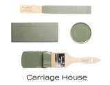 Paintbrush and swatches with Carriage House, a muted green acrylic paint by Fusion Mineral Paint.