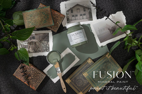 Carriage House Fusion Mineral Paint jar with brush, leaves, vintage photos, and books displaying Fusion branding.