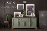 Green sideboard painted in Carriage House Fusion Mineral Paint, shown with decor items on top.